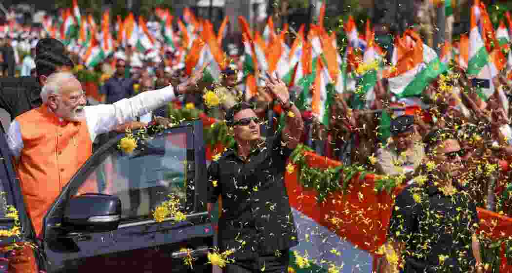 PM Modi during a roadshow in Vadodara, Gujarat. PM Modi during a roadshow in Vadodara, Gujarat.