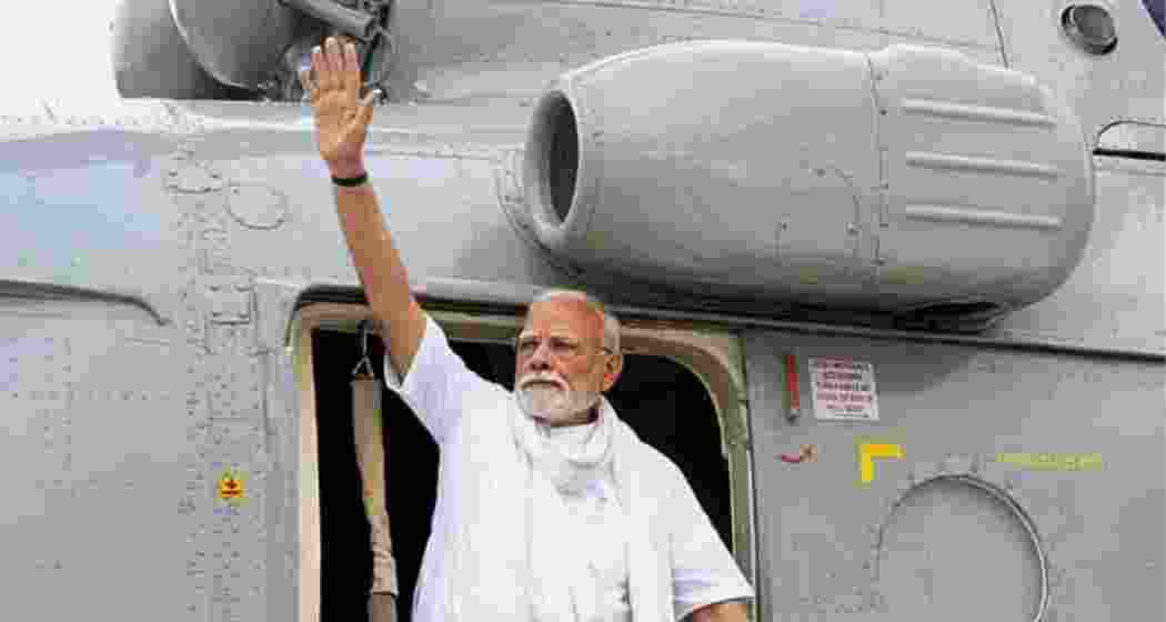 Prime Minister Narendra Modi waves as he arrives to address a public meeting, in Varanasi. Prime Minister Narendra Modi waves as he arrives to address a public meeting, in Varanasi.