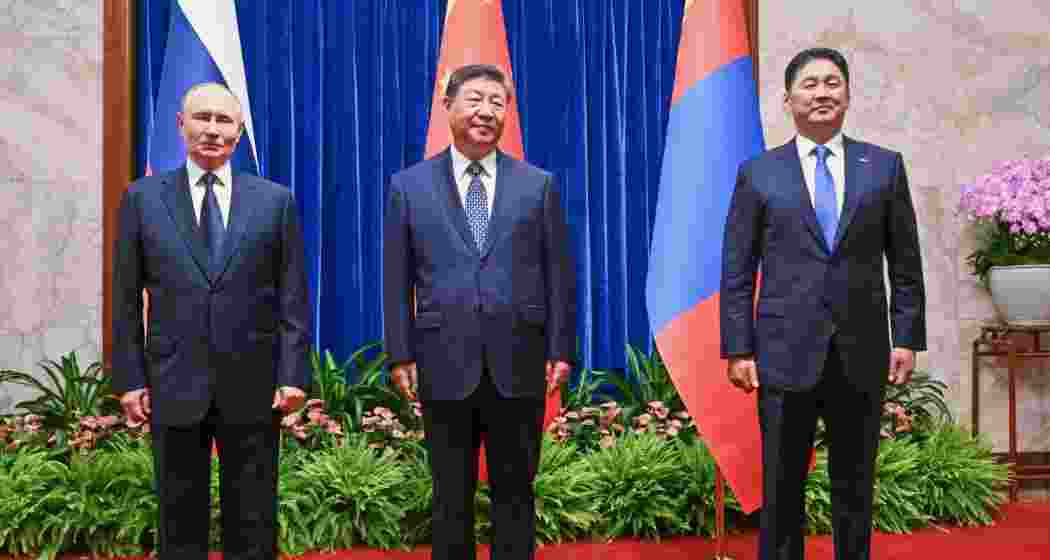 From left, Russian President Vladimir Putin, Chinese President Xi Jinping and Mongolian President Ukhnaagiin Khurelsukh pose for a family photo session ahead of their trilateral meeting in the Fujian Room at the Great Hall of the People in Beijing, China, Tuesday. From left, Russian President Vladimir Putin, Chinese President Xi Jinping and Mongolian President Ukhnaagiin Khurelsukh pose for a family photo session ahead of their trilateral meeting in the Fujian Room at the Great Hall of the People in Beijing, China, Tuesday.