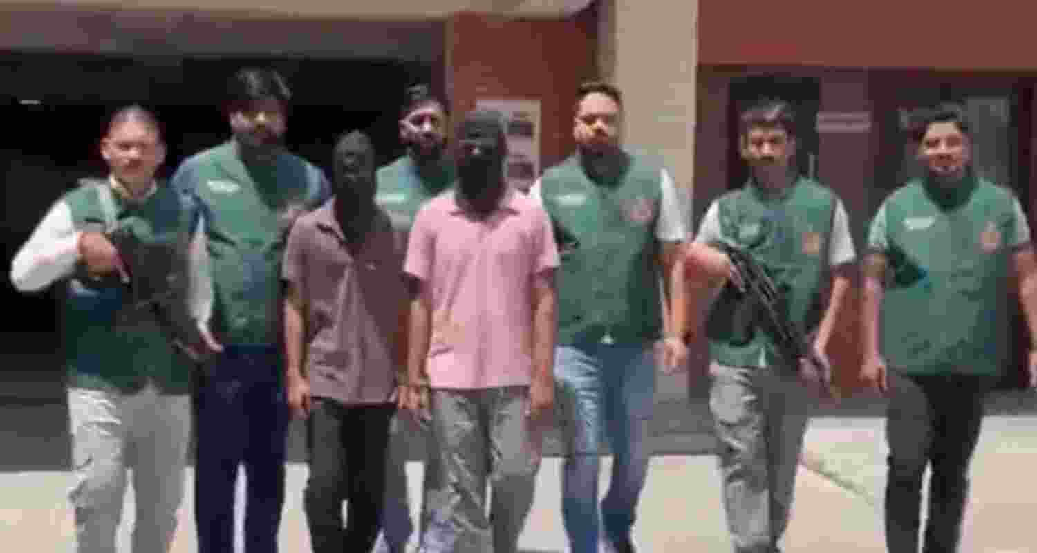 Officials of Special cell Delhi Police with nabbed ISI operatives. Officials of Special cell Delhi Police with nabbed ISI operatives.