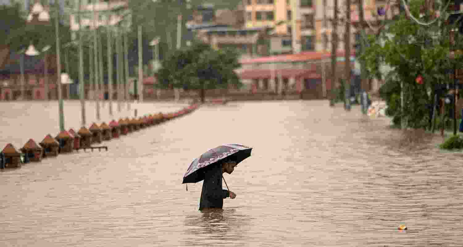 A man walks through floodwaters in Kathmandu. A man walks through floodwaters in Kathmandu.