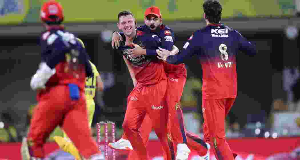 RCB players celebrate the fall of a wicket at Chepauk stadium in Chennai on Friday. RCB players celebrate the fall of a wicket at Chepauk stadium in Chennai on Friday.