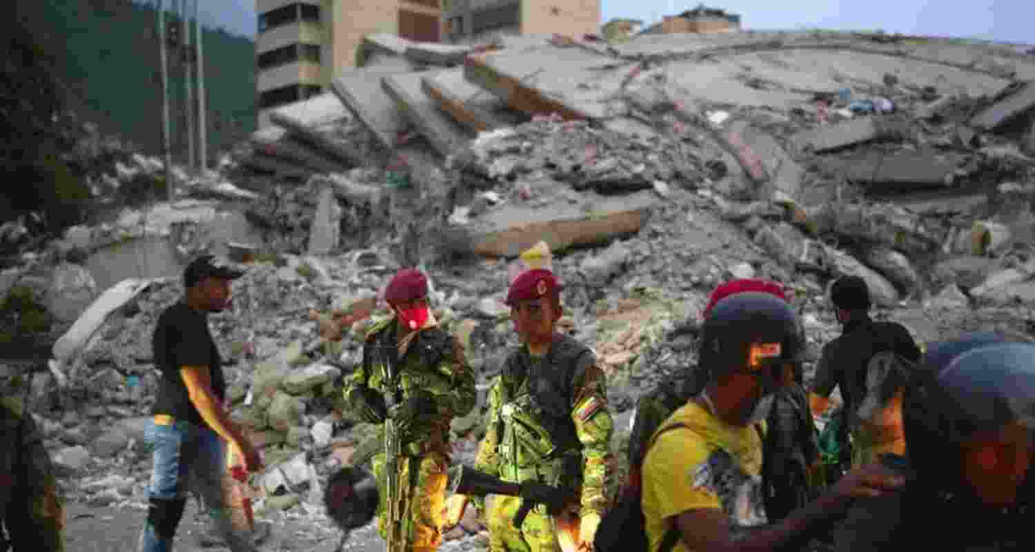Rescue personnel search through the rubble of collapsed buildings following the devastating earthquakes in Venezuela. Rescue personnel search through the rubble of collapsed buildings following the devastating earthquakes in Venezuela.