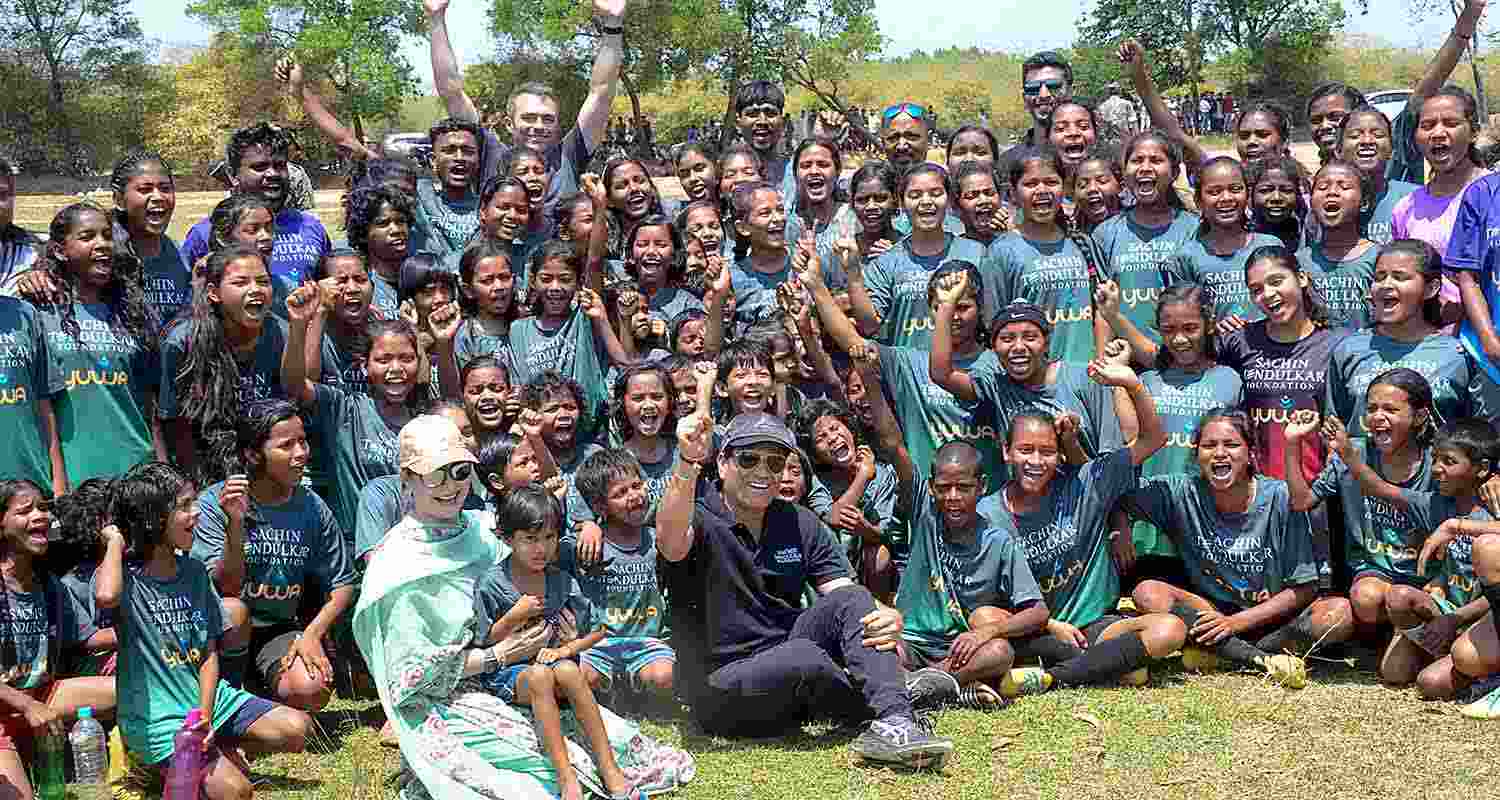 Former cricketer Sachin Tendulkar with wife Anjali Tendulkar pose for group photos with budding football players of Yuwa Foundation, in Ranchi Former cricketer Sachin Tendulkar with wife Anjali Tendulkar pose for group photos with budding football players of Yuwa Foundation, in Ranchi
