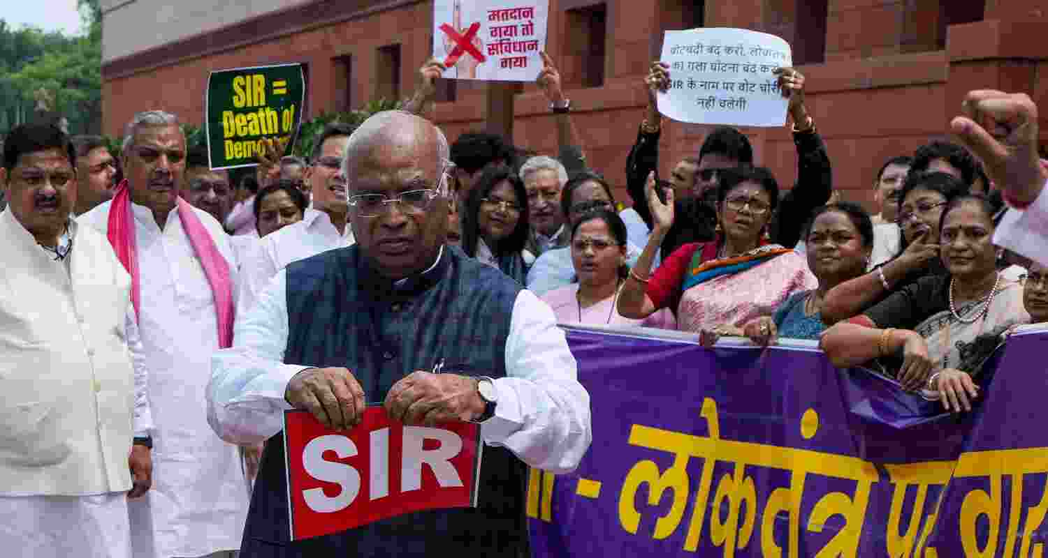 Leader of Opposition in Rajya Sabha and Congress MP Mallikarjun Kharge tears a placard, written SIR on it and dumps it in a dustbin during the Opposition's protest over the Special Intensive Revision (SIR) of Electoral Rolls in Bihar, during the Monsoon session of Parliament, in New Delhi, Friday. Leader of Opposition in Rajya Sabha and Congress MP Mallikarjun Kharge tears a placard, written SIR on it and dumps it in a dustbin during the Opposition's protest over the Special Intensive Revision (SIR) of Electoral Rolls in Bihar, during the Monsoon session of Parliament, in New Delhi, Friday.