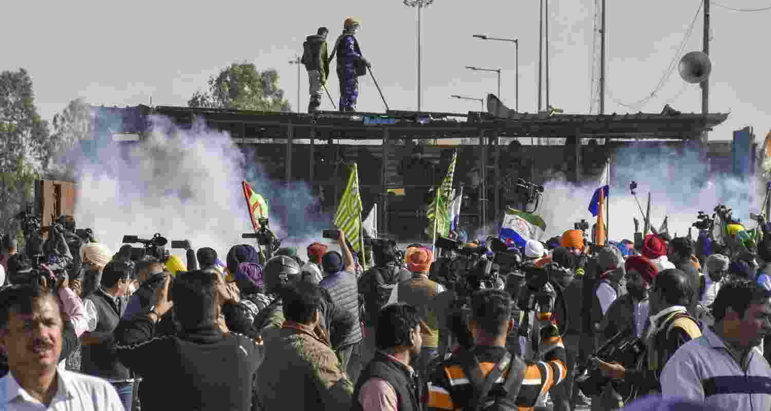 Tear gas being used by security personnel to disperse the farmers moving towards barricades during their foot march to Delhi, at Shambhu border in Patiala district, Punjab, Friday. Tear gas being used by security personnel to disperse the farmers moving towards barricades during their foot march to Delhi, at Shambhu border in Patiala district, Punjab, Friday.