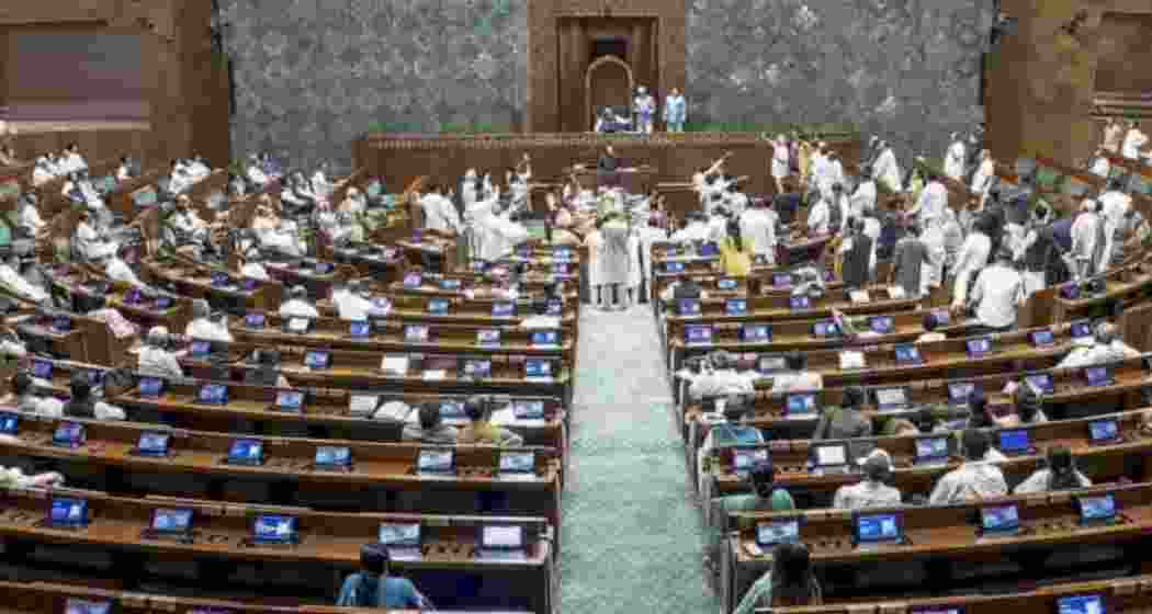 Opposition members protest in the well of the House amid proceedings in the Lok Sabha during the Monsoon Session of Parliament in New Delhi on Friday. Opposition members protest in the well of the House amid proceedings in the Lok Sabha during the Monsoon Session of Parliament in New Delhi on Friday.