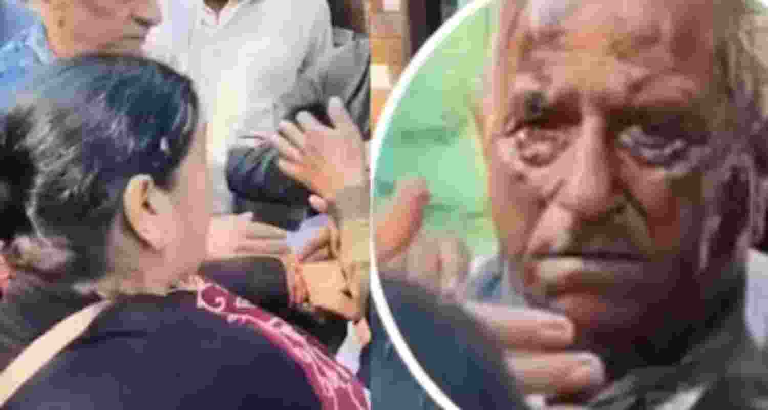 The woman was seen holding an elderly by his collar. The woman was seen holding an elderly by his collar.