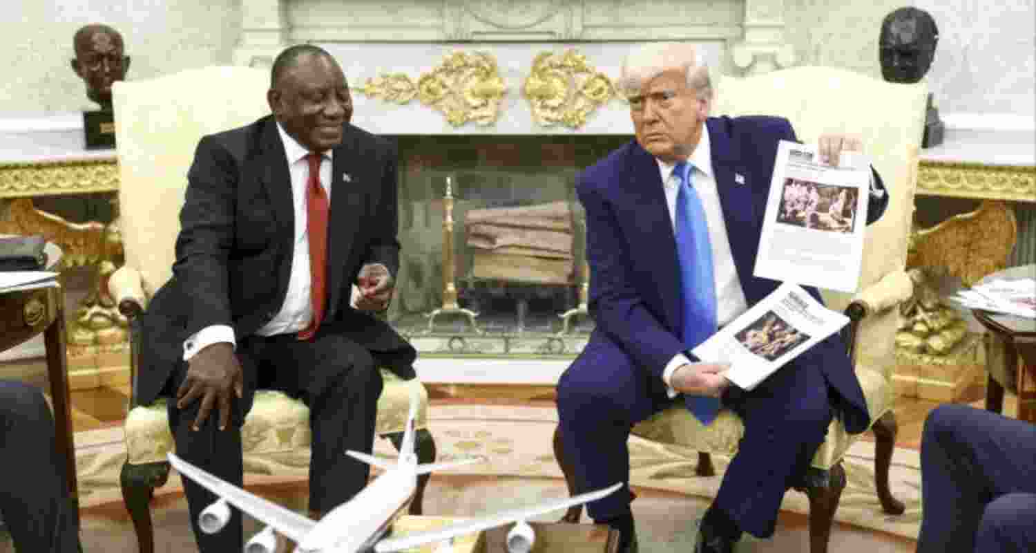 U.S. President Donald Trump (right) holds up a printed article while accusing South African President Cyril Ramaphosa of state-sanctioned violence against white farmers in South Africa during a meeting at the White House in Washington on May 21. U.S. President Donald Trump (right) holds up a printed article while accusing South African President Cyril Ramaphosa of state-sanctioned violence against white farmers in South Africa during a meeting at the White House in Washington on May 21.