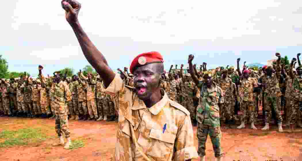Ugandan soldiers stationed near the South Sudan border raise a battle cry during field drills. Ugandan soldiers stationed near the South Sudan border raise a battle cry during field drills.