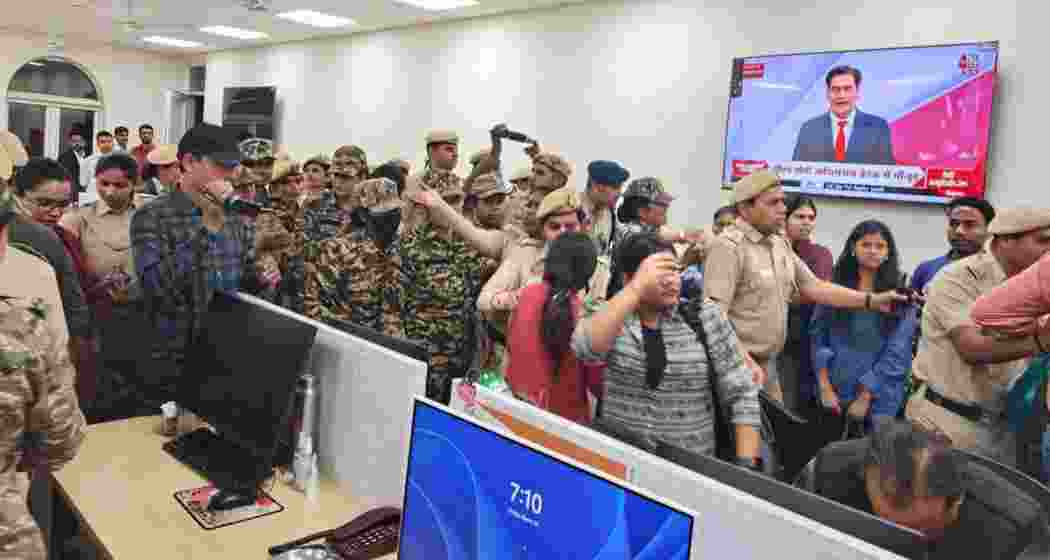 Delhi Police and CRPF personnel inside the UNI office on Friday. Delhi Police and CRPF personnel inside the UNI office on Friday.