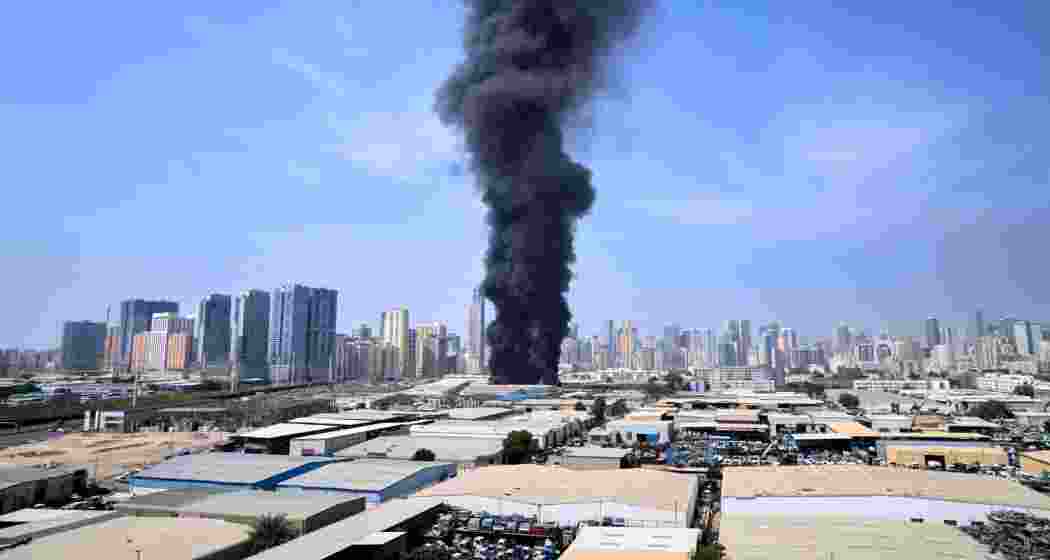 A black plume of smoke rises from a warehouse at the industrial area of Sharjah City in the United Arab Emirates following reports of Iranian strikes in Dubai, United Arab Emirates on Sunday. A black plume of smoke rises from a warehouse at the industrial area of Sharjah City in the United Arab Emirates following reports of Iranian strikes in Dubai, United Arab Emirates on Sunday.