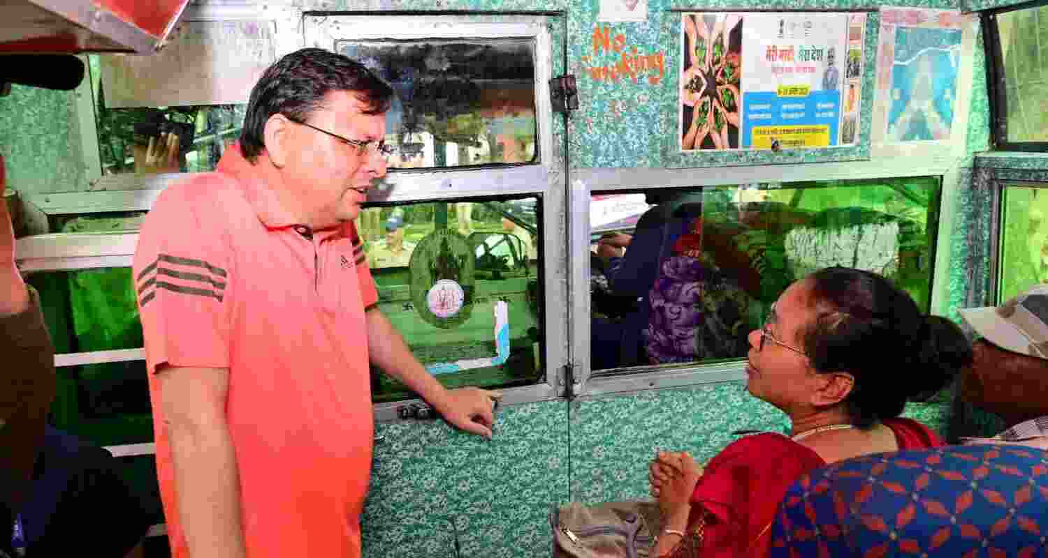 Uttarakhand Chief Minister Pushkar Singh Dhami interacts with a woman who had been airlifted from the flood-hit Dharali village. Uttarakhand Chief Minister Pushkar Singh Dhami interacts with a woman who had been airlifted from the flood-hit Dharali village.