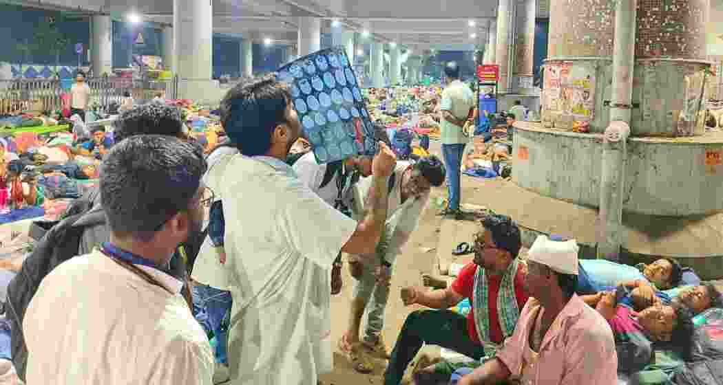 Police and medical personnel attend to injured teachers following a clash with police during a protest over the WBSSC recruitment scam outside Kolkata's Bikash Bhawan late on Thursday. Police and medical personnel attend to injured teachers following a clash with police during a protest over the WBSSC recruitment scam outside Kolkata's Bikash Bhawan late on Thursday.
