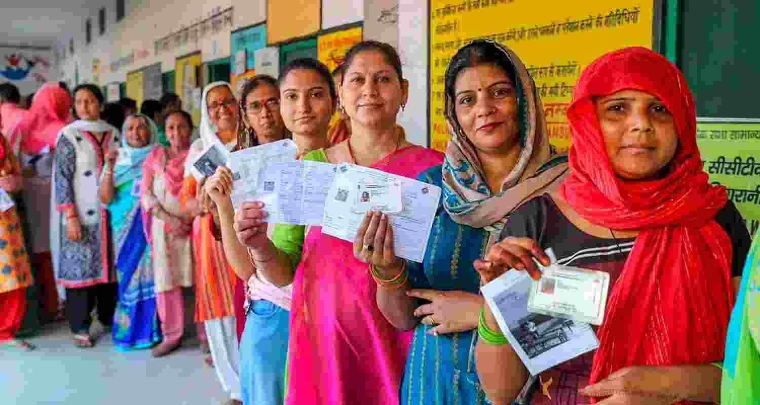 Women line up outside a polling station during the Lok Sabha elections 2024. Women line up outside a polling station during the Lok Sabha elections 2024.