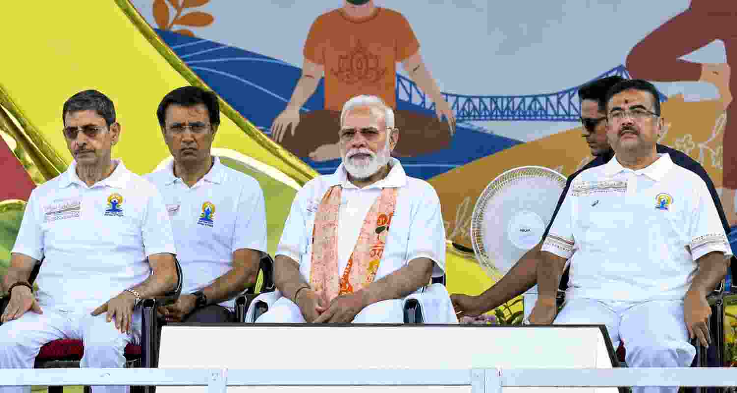 Prime Minister Narendra Modi, West Bengal Chief Minister Suvendu Adhikari and Governor RN Ravi during the 12th International Day of Yoga celebrations, in Kolkata. Prime Minister Narendra Modi, West Bengal Chief Minister Suvendu Adhikari and Governor RN Ravi during the 12th International Day of Yoga celebrations, in Kolkata.